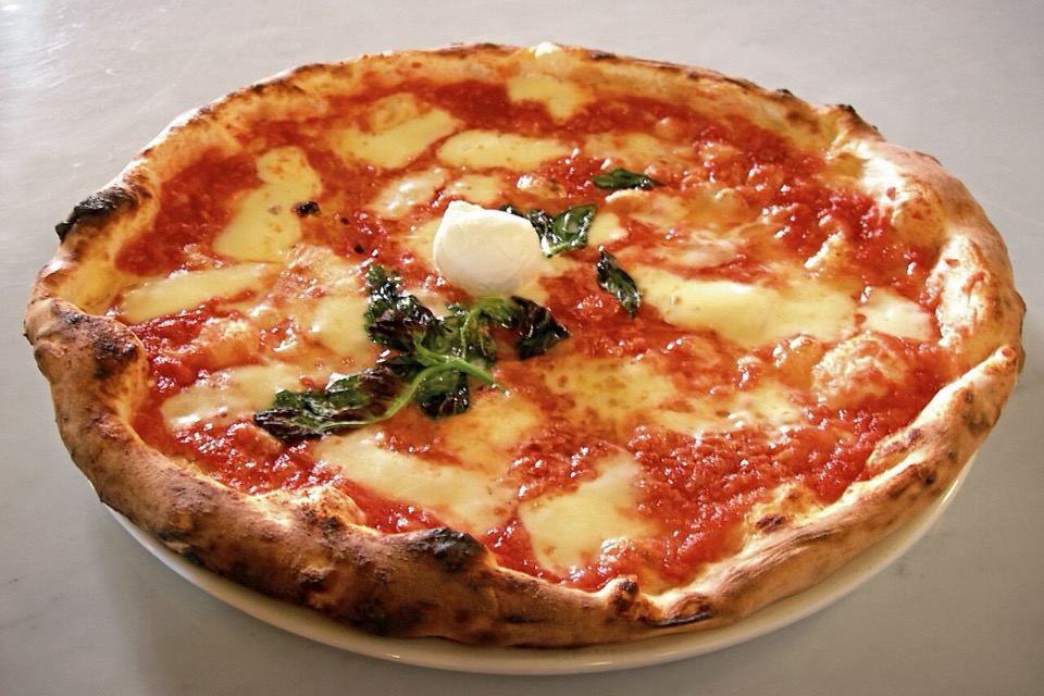 Greasy cheese pizza with toppings